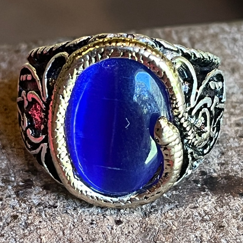 Silver snake with blue stone ring.